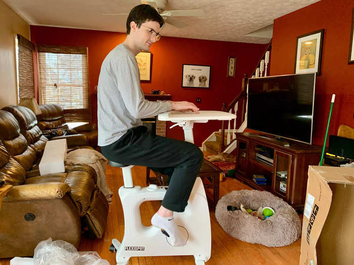 He sat on the bike to make sure everything was on right before fiddling with the adjustments.