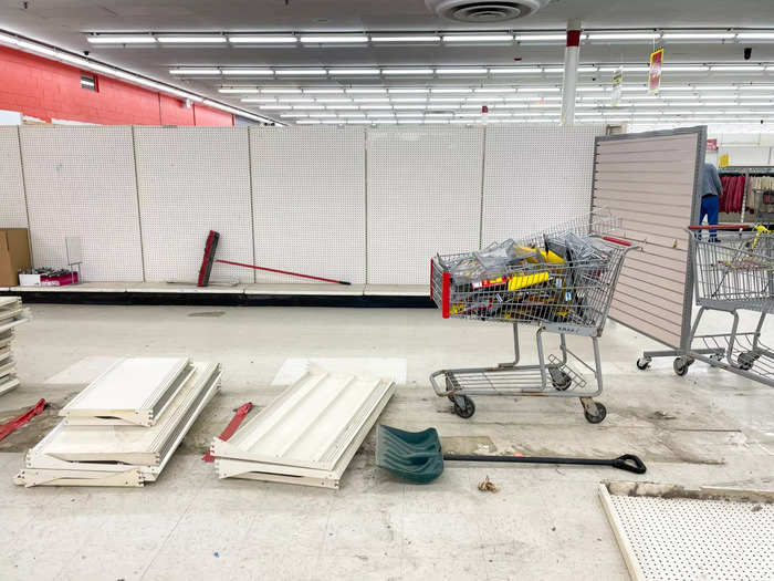 As these shoppers perused, workers continued dismantling displays and shelving units.