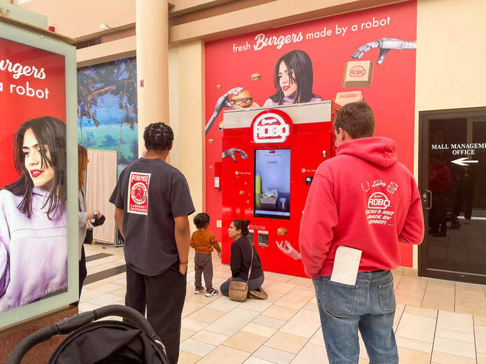 As I stood by the plug-and-play Roboburger, I noticed that it consistently drew in onlookers with its bright red exterior, the smell of cooked meat, large touchscreen, and promise of a fresh burger made by a robot.