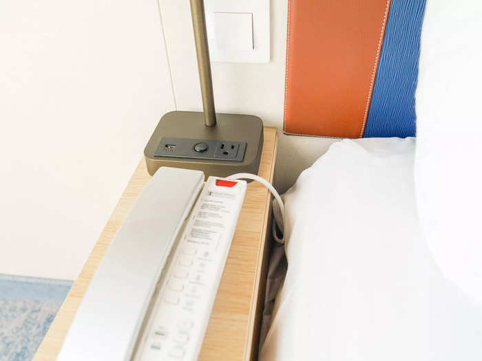 Skinny nightstands on either side of the bed held lamps, charging ports, and a room phone on one side.