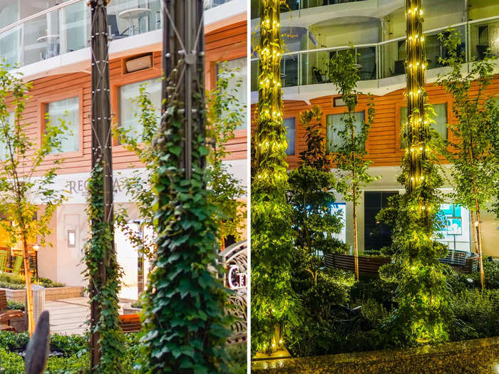 The outdoor deck full of plants lights up yellow at night. It reminded me of my own neighborhood at home during the holiday season.