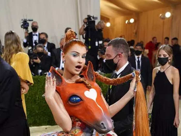 Kim Petras became a real-life horse girl at the 2021 Met Gala with a dress that featured an orange horse head and a true-to-life ponytail.