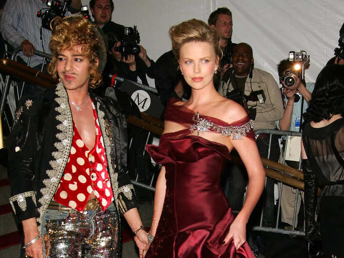 John Galliano walked the 2006 Met Gala red carpet with Charlize Theron in an outfit that had a lot going on.