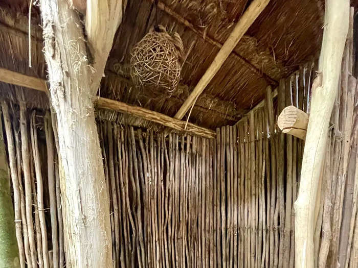 The flushing toilet is in its own covered wooden stall, adding more privacy.