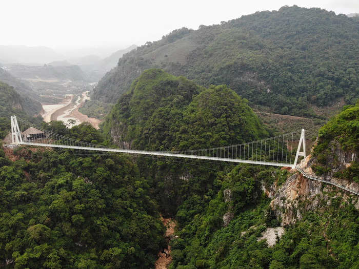 The bridge stands 150 meters, or roughly 492 feet, above a lush valley between two mountains.