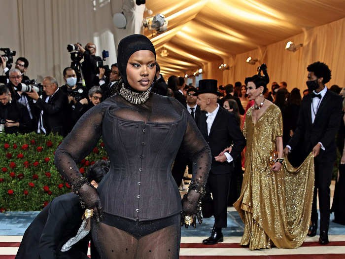 Precious Lee paired a black corset with a see-through gown.