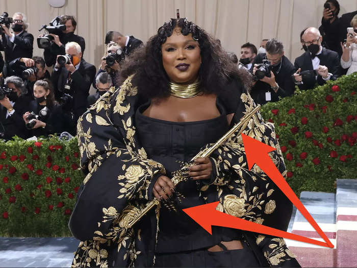 Lizzo wore an intricate hand-embroidered coat and carried a flute, which she played on the carpet.