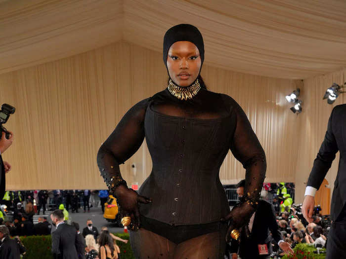 Precious Lee made a statement in a black corset and sheer dress that covered her head.