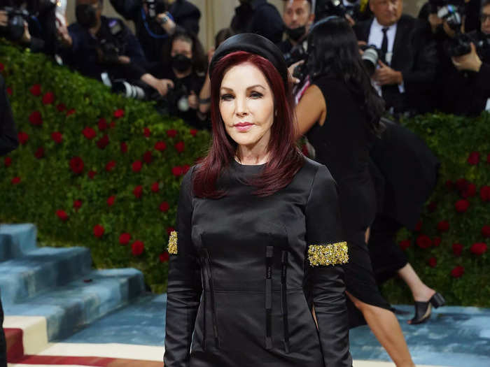 Priscilla Presley looked elegant in a long-sleeved black gown with gold embellishments.