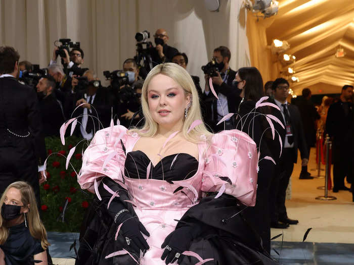 Nicola Coughlan leaned into her "Bridgerton" background by wearing a black corset beneath her pink feathered ball gown.