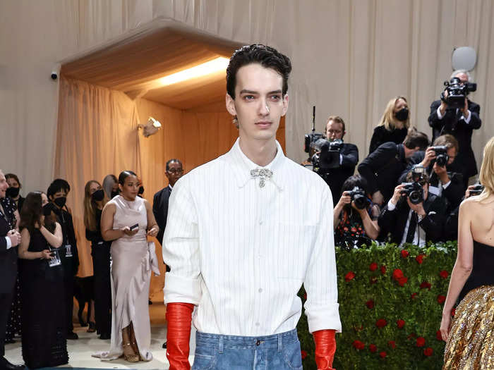 Actor Kodi Smit-McPhee kept in casual in blue jeans and combat boots but amped it up with red leather gloves and Cartier jewels.
