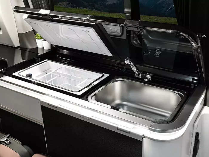 But unlike the Camper 11, this smaller model has a kitchen equipped with a sink refrigerator, storage units, and a small countertop.