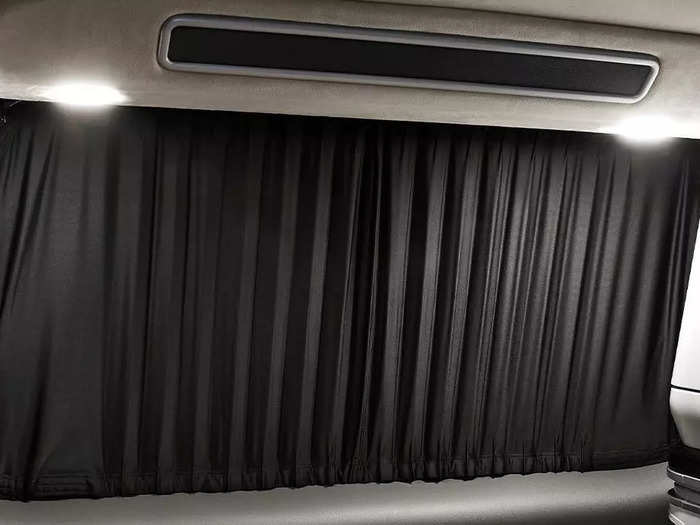 When the blackout curtains are pulled out and the speaker is turned on, the rear of the minivan can turn into a cozy little bedroom.