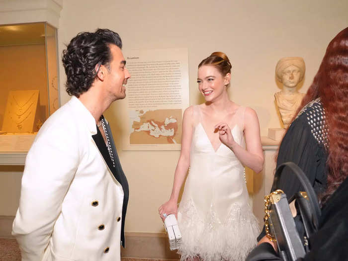 Once inside, Joe Jonas caught up with Emma Stone while surrounded by art.