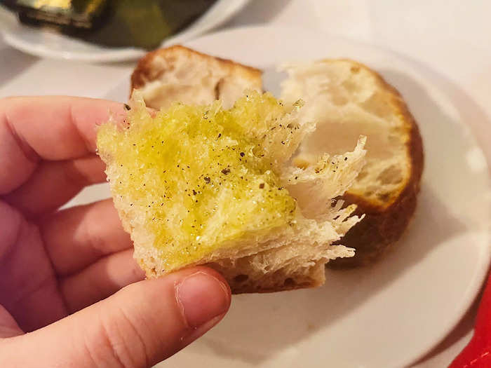 A basket full of bread was swiftly brought to our table, along with pats of butter and olive oil.