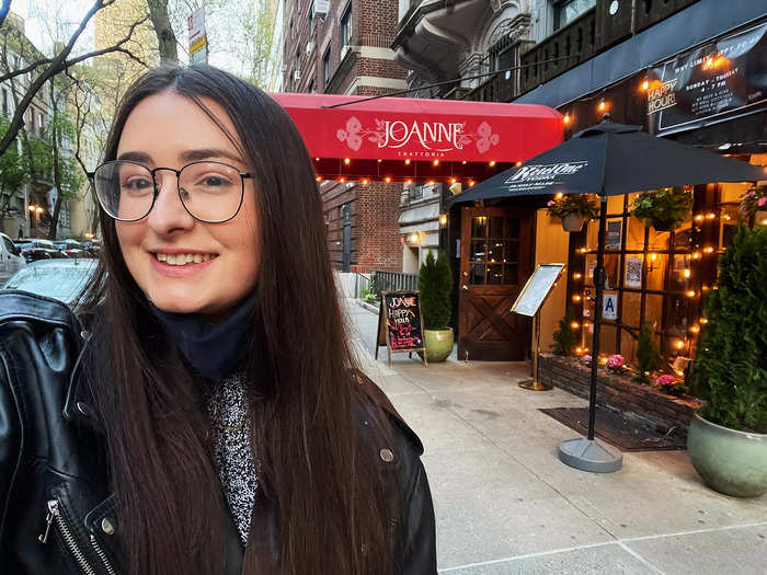 The exterior of Joanne Trattoria was warm and inviting, with a large red awning bearing the restaurant