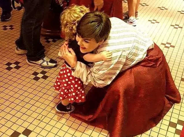 dana hugging a guest at disney world in costume working at the emporium