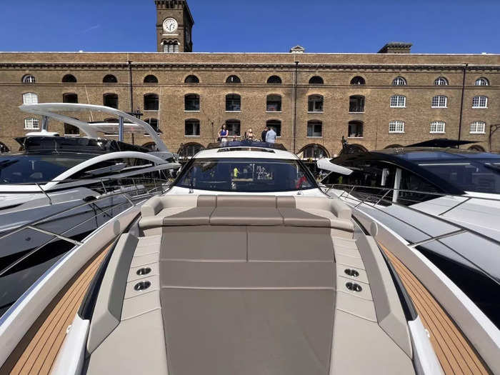 ... as well as an upper deck, or flybridge, which boasts a driving seat, steering wheel, and control panel, situated just above a sunbathing platform.