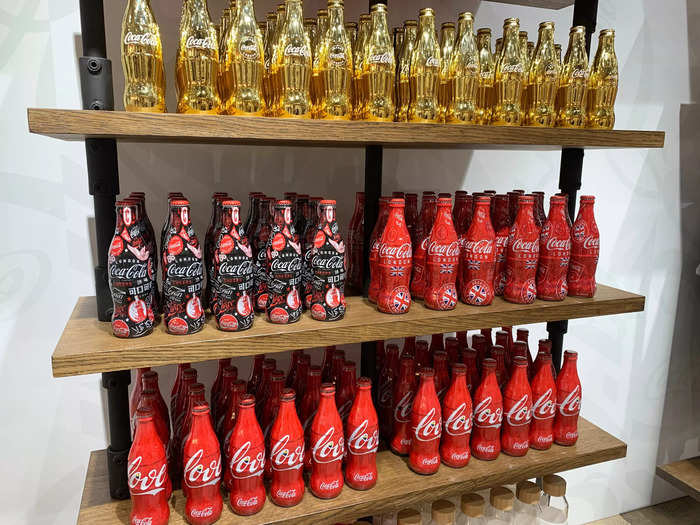 The store also boasts floor-to-ceiling shelves stacked with Coca-Cola collectible bottles ...