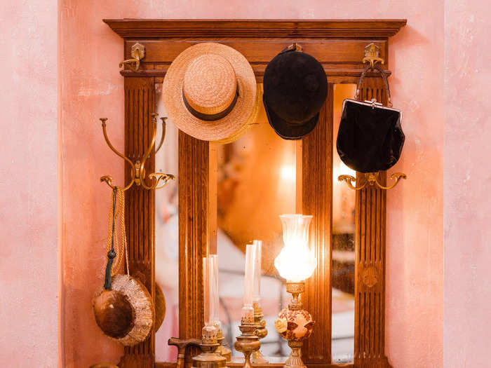 There are also other decorative features such as a hat stand and an antique sewing machine.