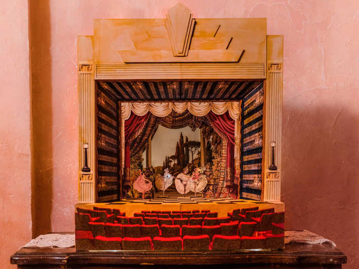 A miniature paper theater of the cabaret sits on top of a cabinet for guests to admire.