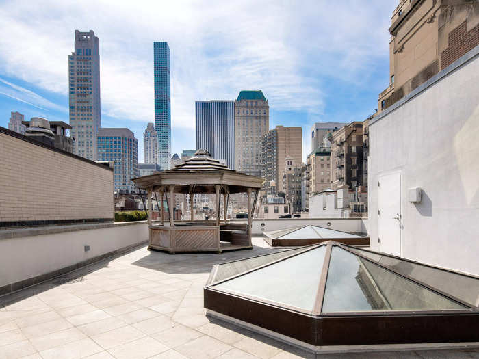 A simple gazebo sits on the roof terrace, offering residents a view of the city skyline.