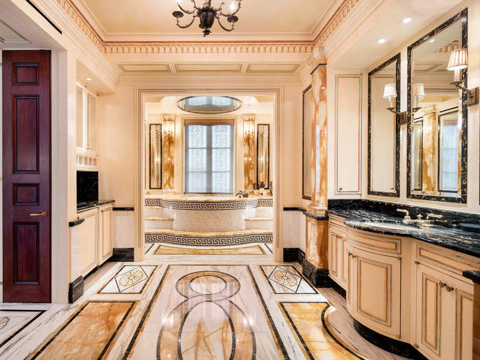 The opulent bathrooms feature ornate details, including Italian marble floors and intricate gold moldings.