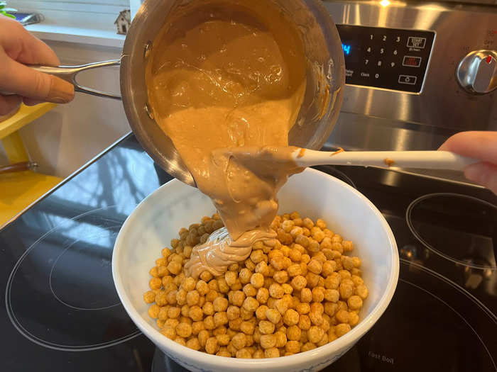 With my cereal ready for coating, I poured the peanut butter and white chocolate mixture on top.