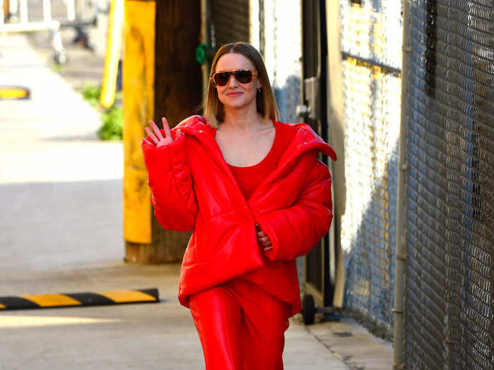 The actress was also seen in all-red outside the show, this time featuring a puffer coat and white boots.