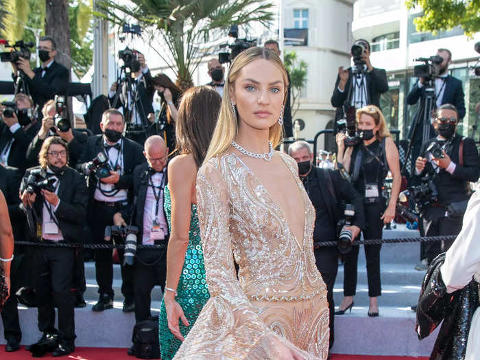 Candice Swanepoel attended the 2021 Cannes Film Festival wearing a sheer jumpsuit with embroidered sequins and a plunging neckline.