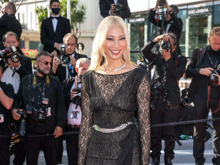 Soo Joo Park walked the red carpet at the 2021 Cannes Film Festival in a black lace jumpsuit with a dress overlay.