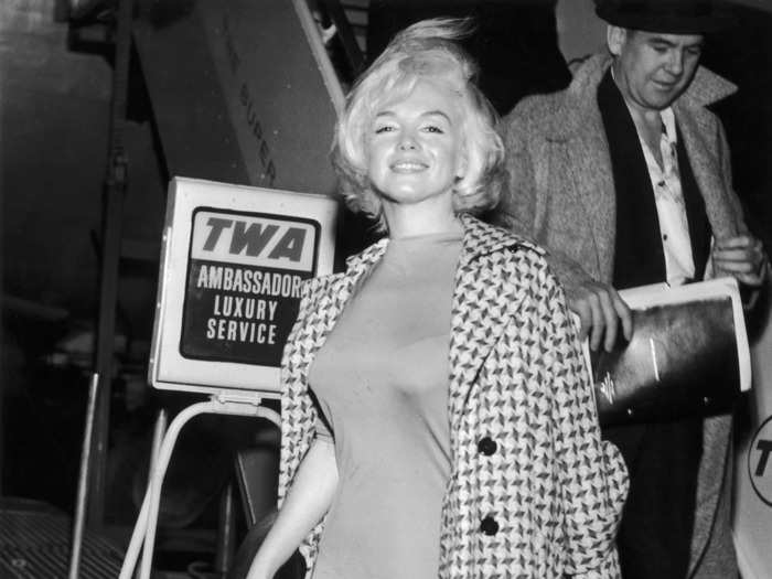 Arriving at what is now LaGuardia airport in 1961, Monroe honored her chic reputation in an over-the-knee dress with a wool coat over her shoulders.