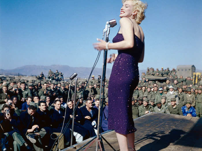 Monroe wore a sparkly purple midi dress to entertain US troops in South Korea in 1954.