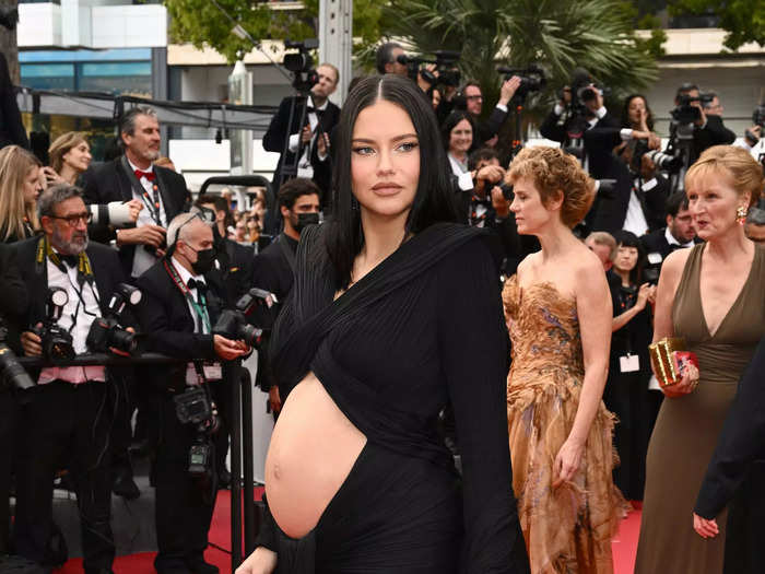 Adriana Lima walked the red carpet in a pleated gown that had a cutout for her baby bump.