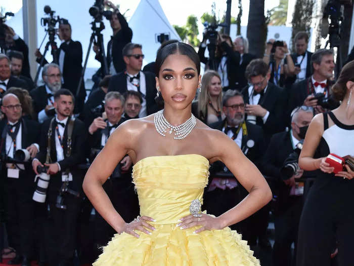 Lori Harvey looked incredible in a strapless yellow gown with diamond accents.