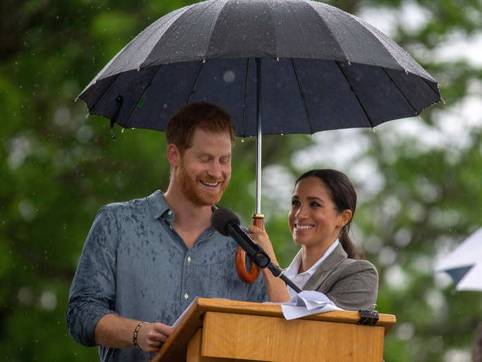 Later that day, Markle and Harry shared an umbrella in the rain.