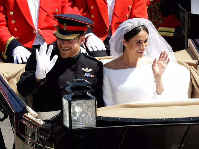 After their wedding ceremony, the couple cheerily waved to fans while riding in a carriage procession.