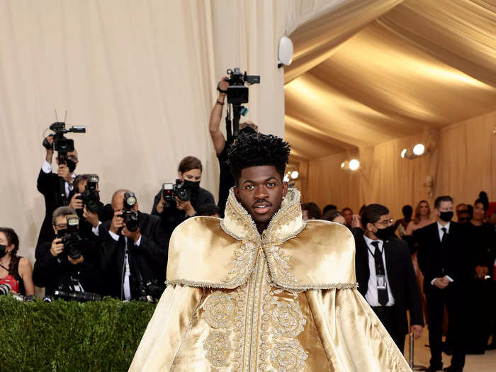 Lil Nas X had a regal moment in a gold floor-length cape at the 2021 Met Gala celebrating the theme "In America: A Lexicon Of Fashion."