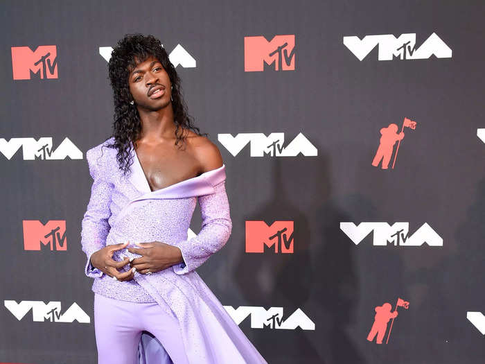 The singer blurred the lines between masculine and feminine at the Video Music Awards 2021, in a long wig and a lilac pantsuit with a dress detail on one side.