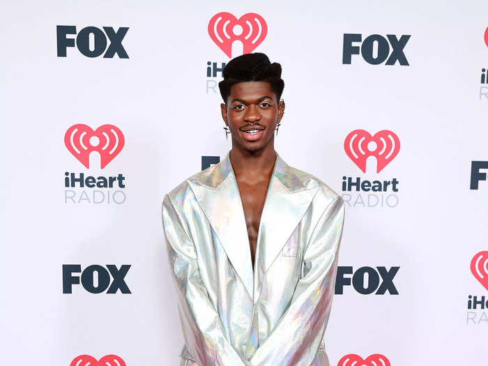 He dazzled in an iridescent-silver suit with a tiny Telfar handbag at the 2021 iHeartRadio Music Awards.