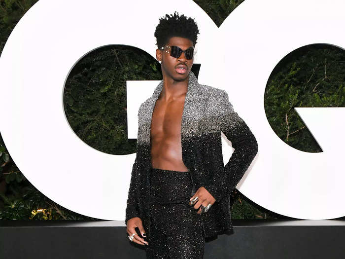 Sticking to sparkles and a suit, Lil Nas X opted for darker hues at the GQ Men of the Year Celebration 2021.