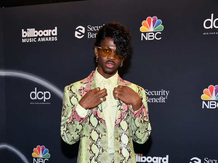 Lil Nas X opted for cascading curls with a green-and-coral snakeskin suit for the 2020 Billboard Music Awards.