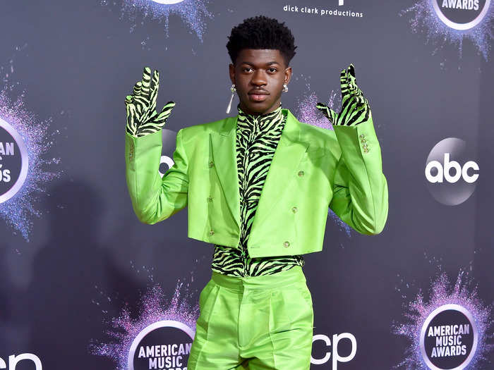 Lil Nas X channeled Prince in neon green and zebra print on the red carpet for the 2019 American Music Awards.