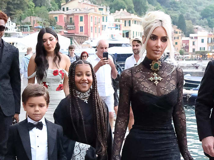 Kim Kardashian wore a black lace gown as she walked to the ceremony with her daughter North West, and Kourtney