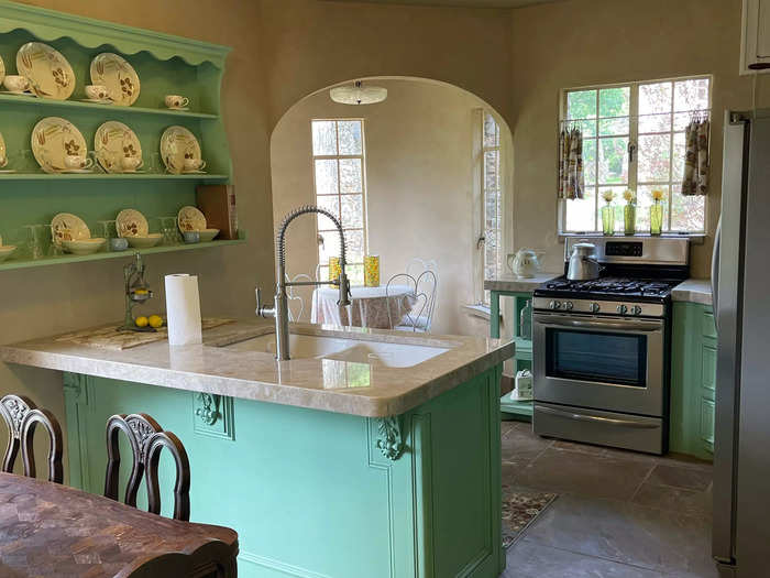 The combined kitchen and dining area was formed by knocking down two walls to create an open-concept space.