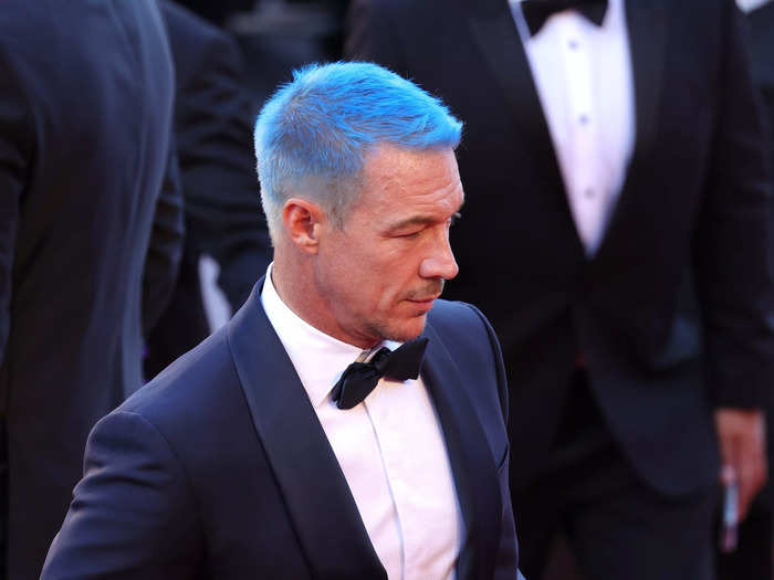 Major Lazer DJ Diplo rushed through the red carpet sporting bold blue locks.