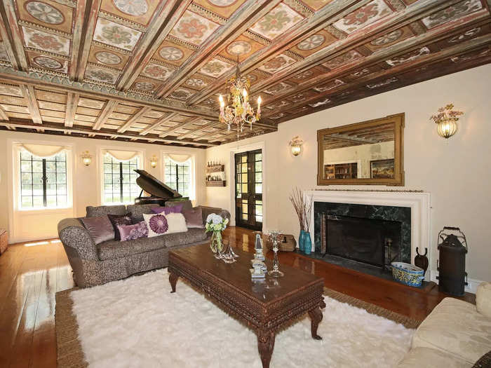 Hand-painted coffered ceilings adorn the formal living room.