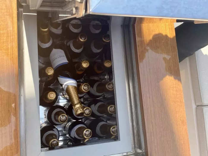 The champagne ice cooler is on the main deck and can fit... quite a number of bottles.