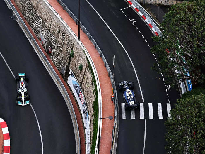 Lewis Hamilton and Pierre Gasly pass each other in opposite directions.