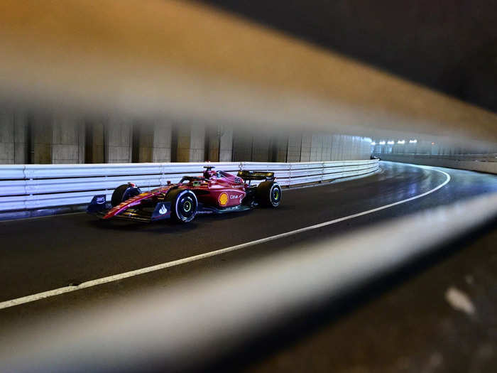 Charles Leclerc seen through the railing in the tunnel.